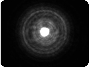 Black background with a bright light in the middle, with a halo around the light larger than the AcrySof® IQ Monofocal and AcrySof IQ Vivity® IOLs, representing the optical bench halo measurement for TECNIS Symfony Diffractive EDF IOL