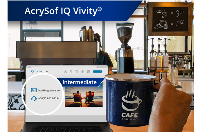Clear image of a coffee shop with a view from the counter of coffee machines and other ingredients. A laptop is open on the countertop and an individual’s hand holds up a coffee mug to the right of the laptop screen. White text at the top left corner of this image reads “AcrySof IQ Vivity.”